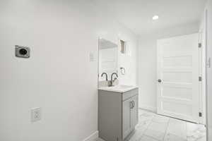 Bathroom with tile patterned floors and vanity