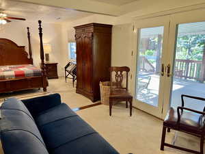 Carpeted bedroom with ceiling fan, french doors, a textured ceiling, and access to exterior