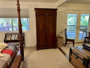 Carpeted bedroom featuring access to outside and french doors