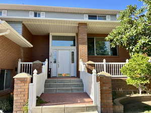 Property entrance with covered porch