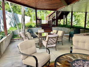 View of patio / terrace with a wooden deck and an outdoor living space with a built in gas grill