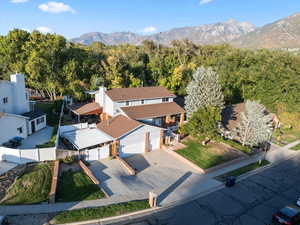 Aerial photo of front of house, property, street and neighboring houses