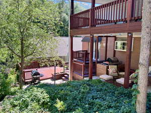 View of back patio / terrace featuring grilling area and multiple decks