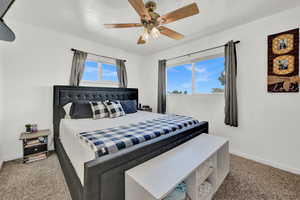 Carpeted bedroom with ceiling fan