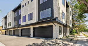 View of building exterior with a garage and driveway