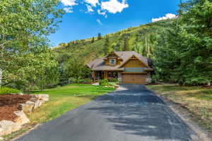 Craftsman inspired home with a garage and a front yard