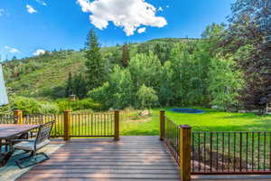 Deck featuring a lawn