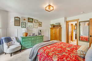 Bedroom featuring light carpet