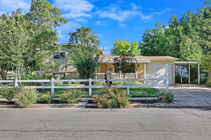 View of front of house with a carport and a garage