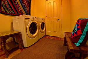 Laundry area with washing machine and clothes dryer, linen/storage closet