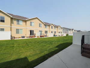 Exterior space featuring a patio, a yard, and central AC