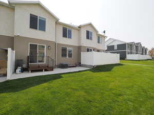 Back of house featuring a yard, a patio, and cooling unit