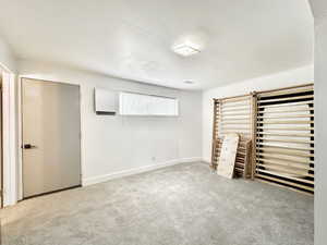 Unfurnished bedroom with light colored carpet