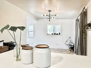 Dining area featuring a notable chandelier and light tile patterned flooring