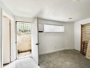 Carpeted bedroom featuring multiple windows