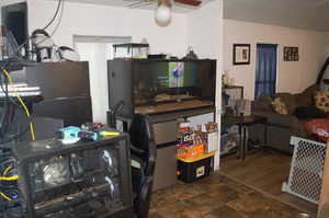 Kitchen featuring ceiling fan, fridge, and dark hardwood / wood-style flooring