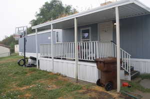 View of property exterior featuring a porch