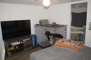 Bedroom featuring a textured ceiling, ceiling fan, and wood-type flooring