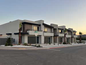 Outdoor building at dusk featuring a garage