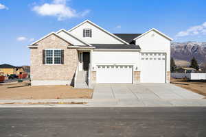 View of front of home featuring a mountain view and a garage