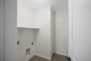 Laundry area with electric dryer hookup, a textured ceiling, and hookup for a washing machine