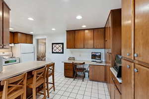 Kitchen featuring white appliances and light tile patterned floors