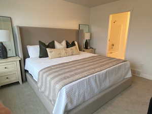 Photo of the Dawson Place model home, showing furnished example of similar floorplan. Primary bedroom