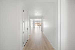 Corridor featuring light wood-type flooring