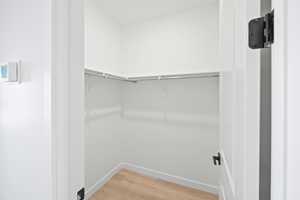 Spacious closet featuring hardwood / wood-style floors