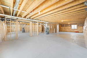 Basement featuring heating unit