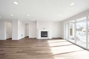 Unfurnished living room featuring hardwood / wood-style flooring