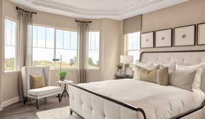 Bedroom featuring wood-type flooringPicture of model colors and materials may vary.