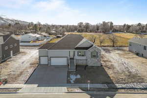 View of front facade with a mountain view, a garage, and central AC unit