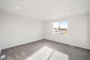 View of carpeted spare room