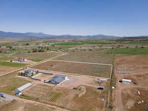 Birds eye view of property with a rural view and a mountain view