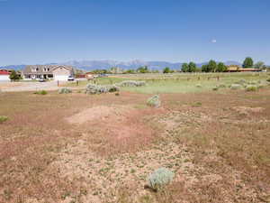 View of yard featuring a rural view and a mountain view