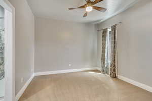 Main Bedroom with ceiling fan and North window.