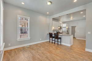 Looking left from the living room at the dining area and kitchen.