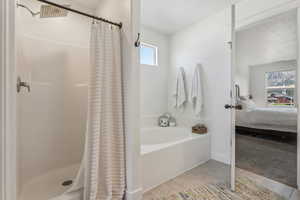 Bathroom with plenty of natural light, tile patterned floors, and a shower with curtain