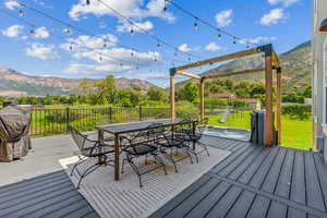 Wooden terrace featuring a mountain view and a playground