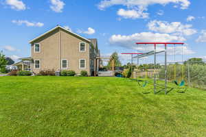 Exterior space featuring central AC and a yard