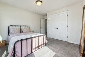 Bedroom featuring a closet and carpet floors