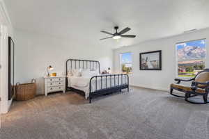 Master Carpeted bedroom with ceiling fan