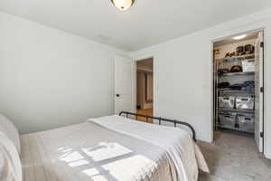 Bedroom featuring a spacious closet and a closet