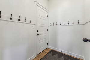 Mudroom with light hardwood / wood-style flooring