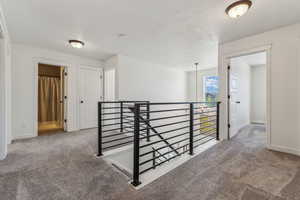 Hallway featuring carpet floors