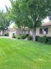 Single story home with a garage and a front yard