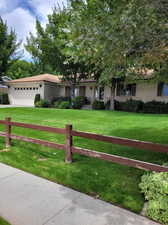 View of front of property with a garage and a front yard