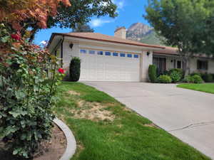 View of front facade with a front yard and a garage