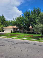 View of front of home with a front lawn and a garage